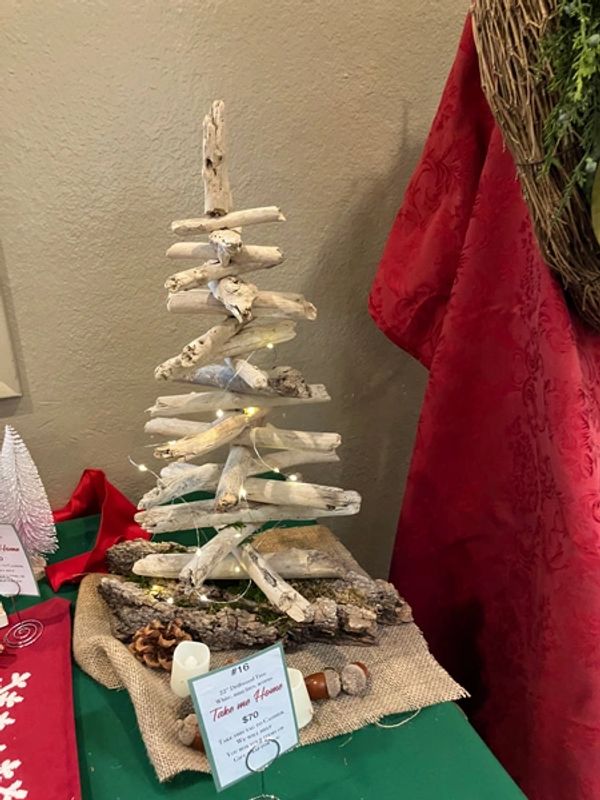 Decorative Holiday tree made from driftwood with small lights.