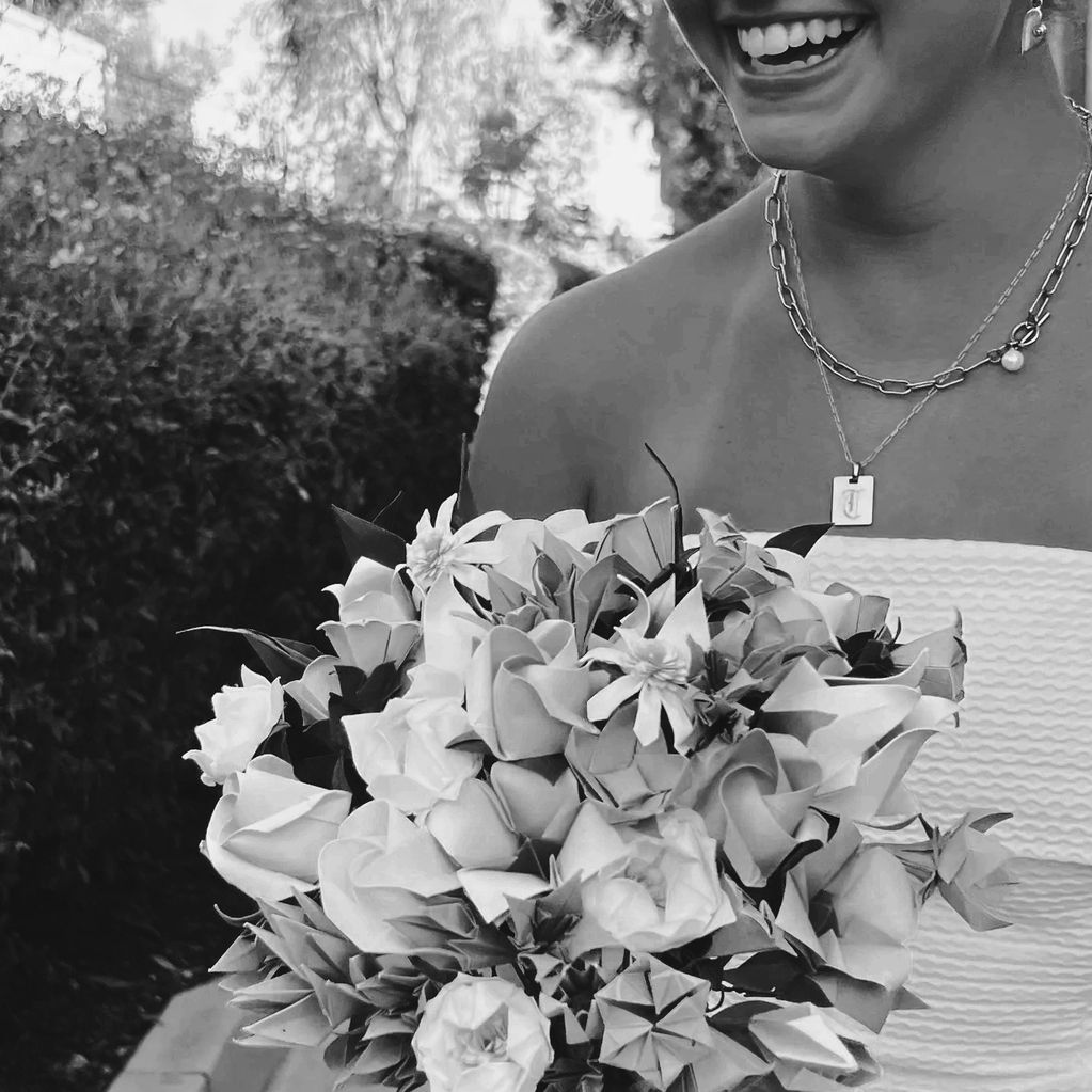 young bride smiling holding her origami bouquet