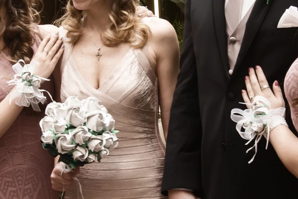 origami roses bouquet in silver paper. Bride, groom and daughters at Anniversary reception