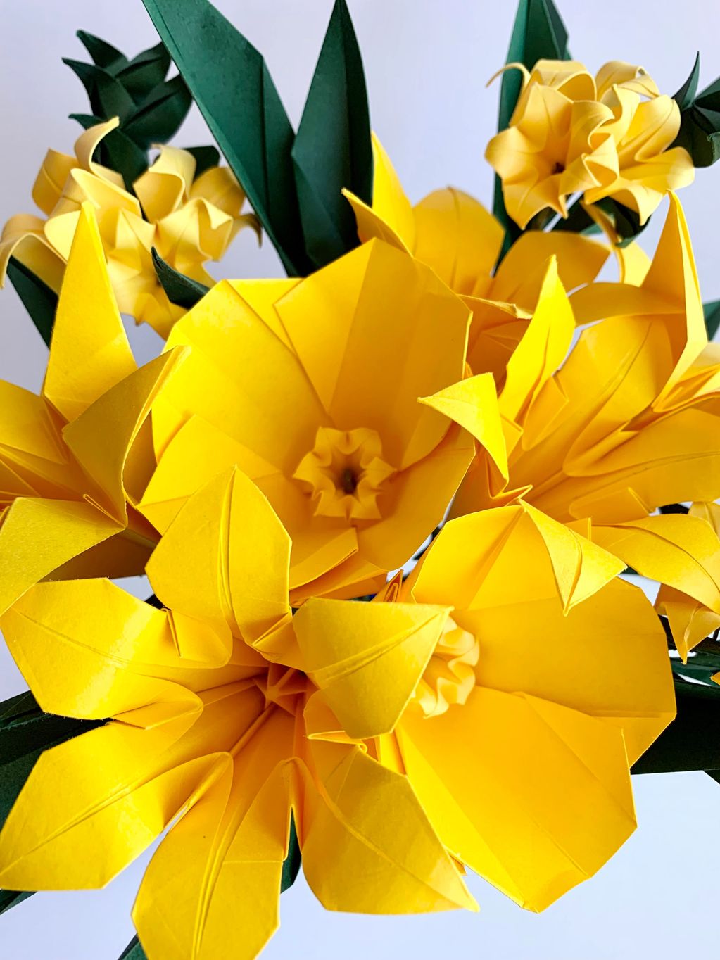 yellow flowers origami bouquet with dark green leaves