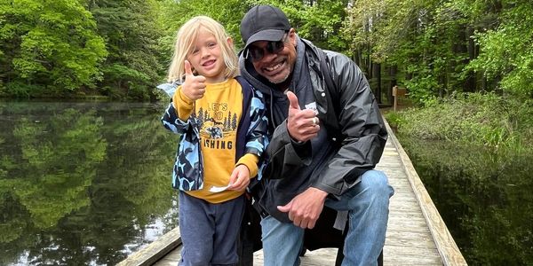 Veteran teaching child how to fish at our annual Buddies & Bobbers fishing derby.