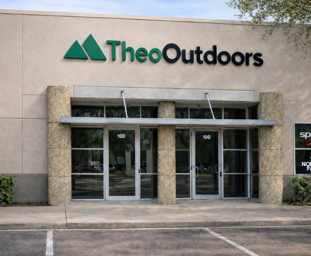Entrance of Theo Outdoors store with glass doors and stone pillars.