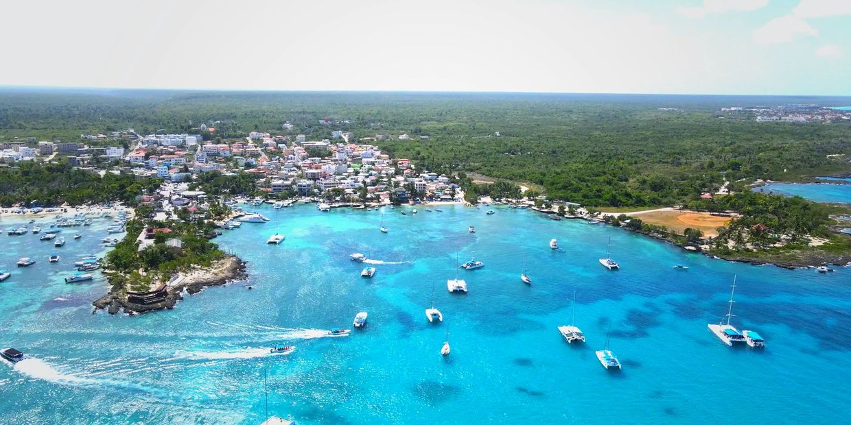 drone shot of the bay, pier and marina of Bayahibe Dominican Republic, crystal clear water and boats