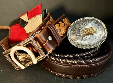 vintage western leather belts with embossing and whip stitching along with belt buckles. also super