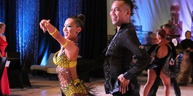 Bonnie with her dance partner, Elvin, performing at a ballroom dance competition. 