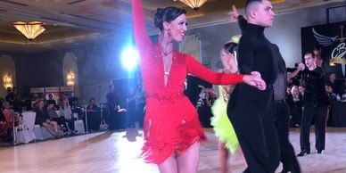 Aleksandr competing Cha Cha with his student Grace at a ballroom dance competition. 