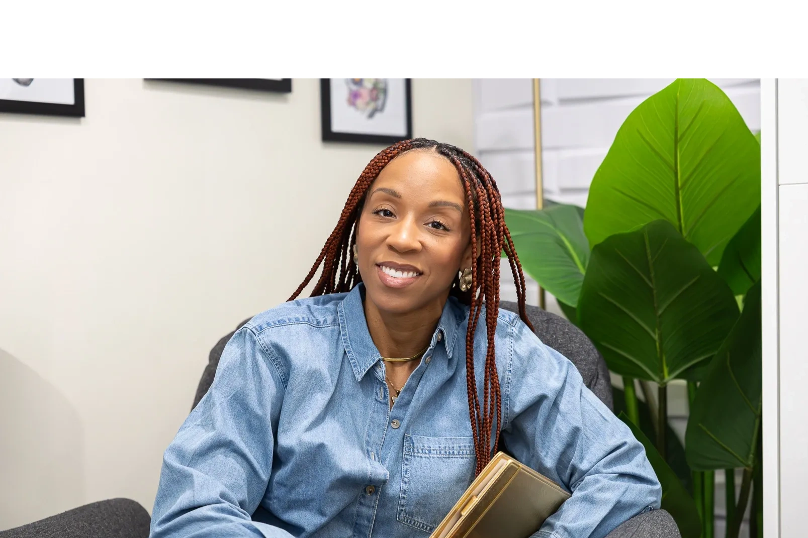 Dr. Shari Andrews smiling, seated with a book.