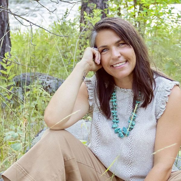 Marni Henderson is sitting on the ground