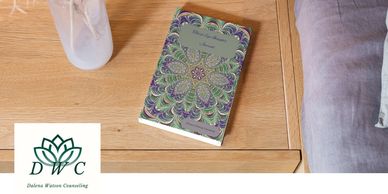 Third Insights Journal on night stand with flowers and side of the bed showing.