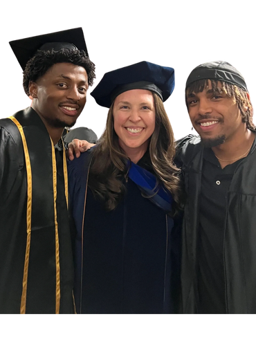 Three smiling graduates in caps and gowns celebrating together.
