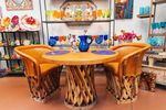 Rustic leather chairs and wooden table with handcrafted designs at Native Gardens of Green Valley
