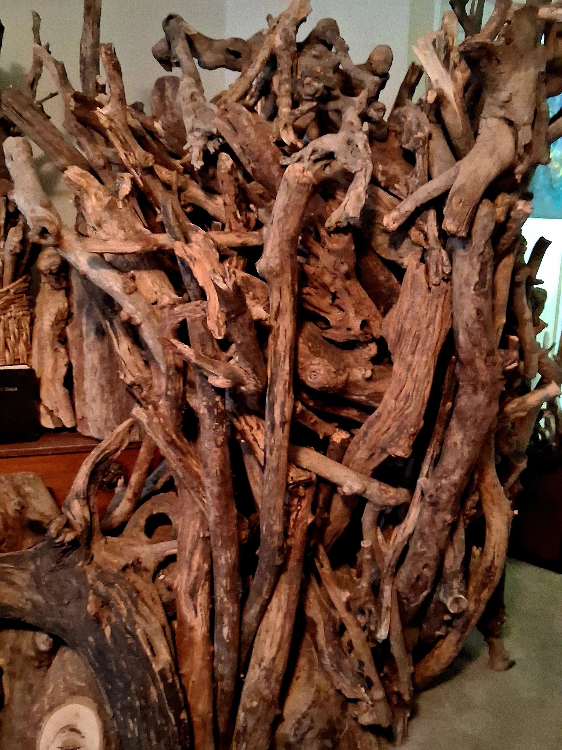 A dense pile of intertwined, weathered tree branches and roots.