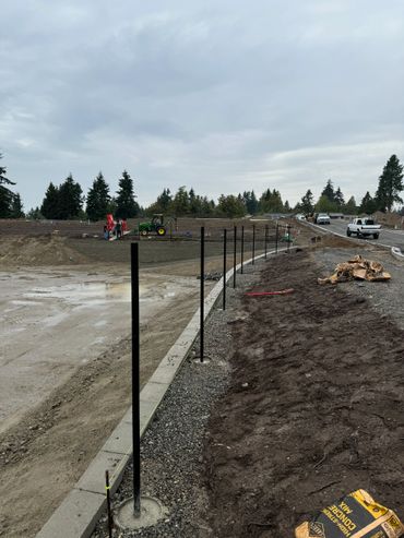 A construction site with trees and dirt in the background.