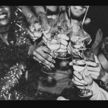 People toasting with champagne glasses in celebration.