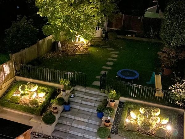 Illuminated Backyard Garden During Night Hours