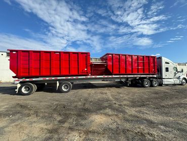 Red roll-off containers loaded on a flatbed, Elite Containers, Waterbury CT
