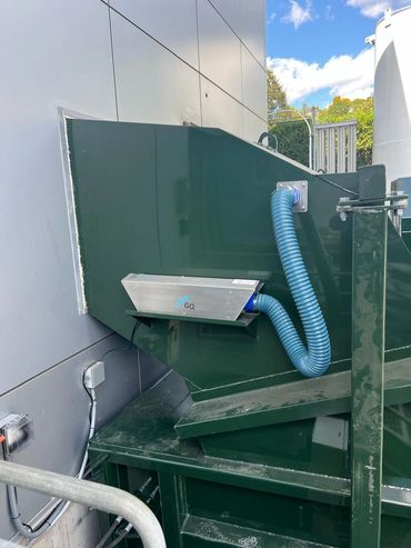 Exterior trash chute with odor control unit feeding compactor, Elite Containers build-out