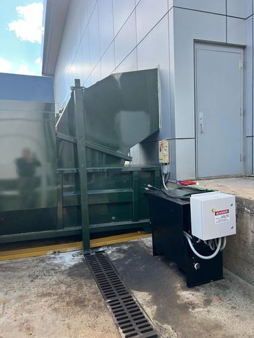 Self-contained compactor with wall chute and power unit, Elite Containers build-out