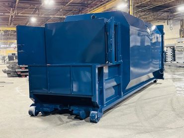 Blue self-contained compactor in the shop, Elite Containers, Waterbury CT