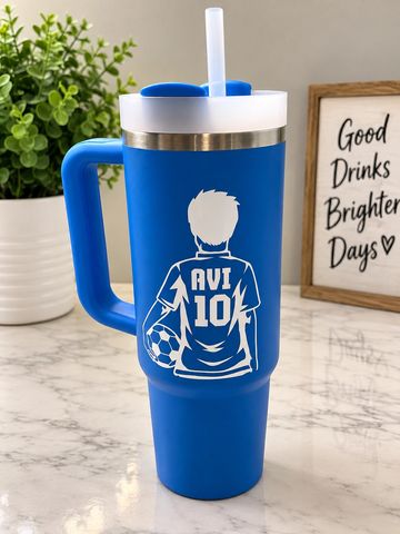 Blue travel tumbler with soccer design and straw.