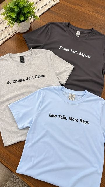 Three motivational workout t-shirts with different slogans.