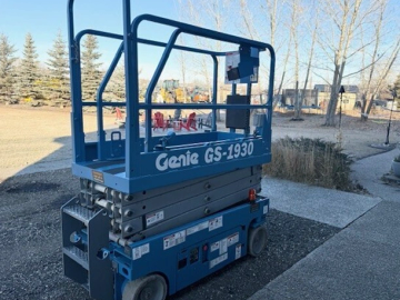 Blue Genie GS-1930 scissor lift parked on a driveway.