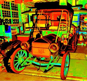 Colorful vintage car displayed indoors with bright lighting effects.