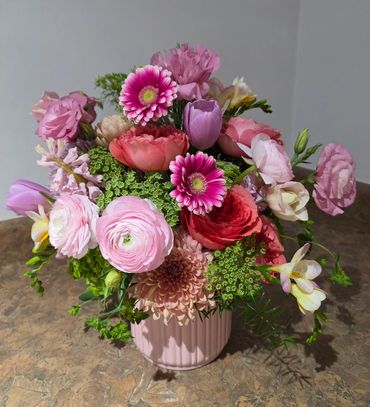 Gerbera Daisy and Ranunculus flower arrangement in pink vase