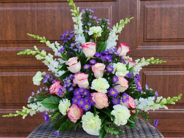 Roses, Snapdragons, Monte Casino and Carnation funeral arrangement