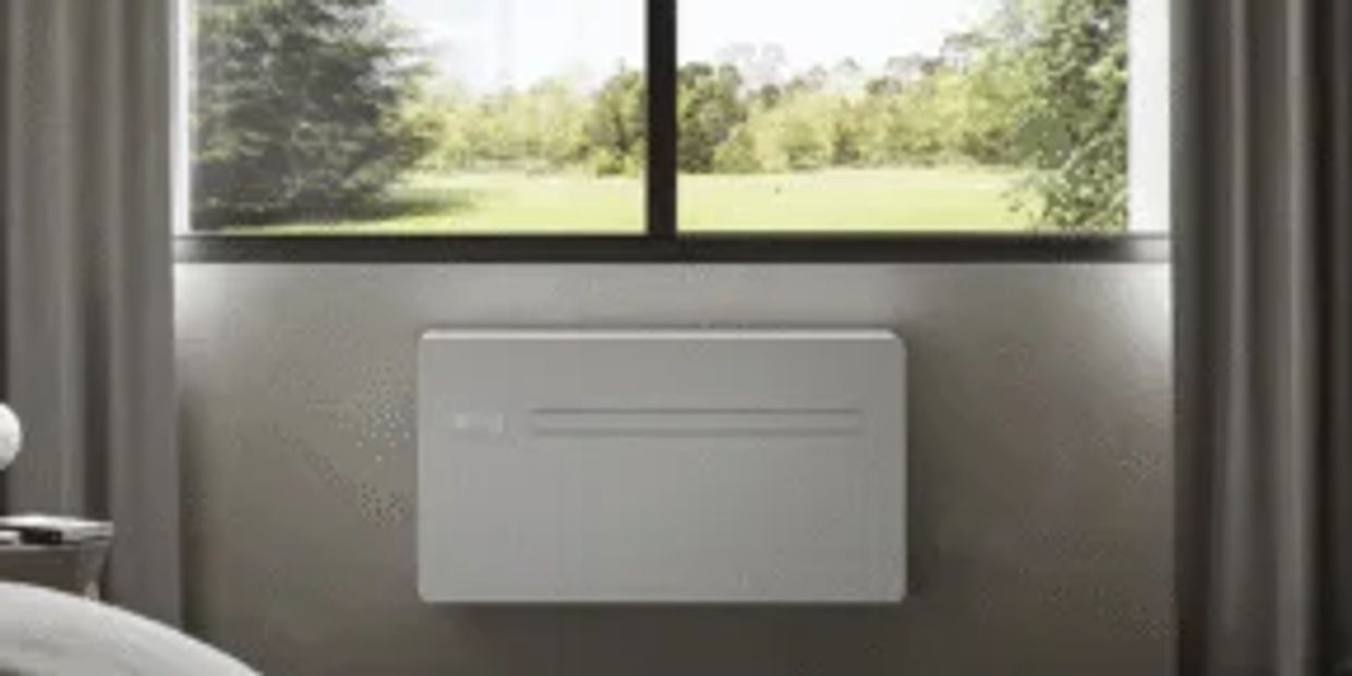 Modern wall-mounted heater below a window.