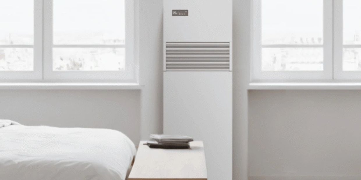 Minimalist bedroom with a bed, window, and a white air purifier.