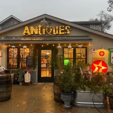 Cozy antique shop entrance at dusk with warm lighting.