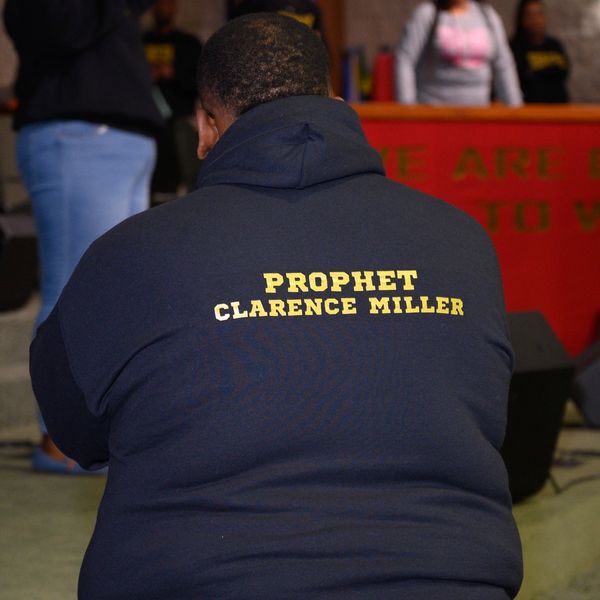 Person wearing a hoodie with 'Prophet Clarence Miller' printed on the back.