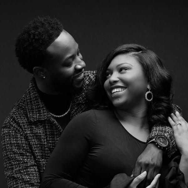 Black and white photo of a couple smiling and embracing tenderly.