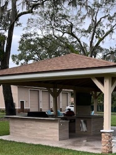 outdoor bar and kitchen area with pavilion and spacious yard