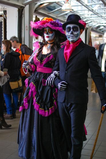 Catrin and Catrina couple in black and magenta clothing parading at the Harbourfront Centre
