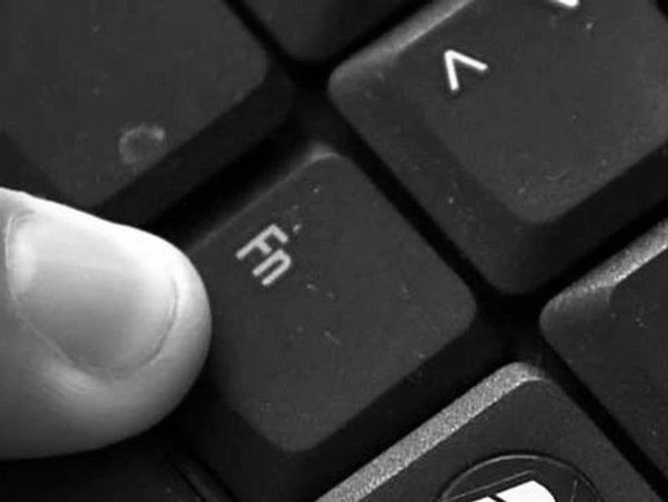 Finger pressing Fn key on keyboard.