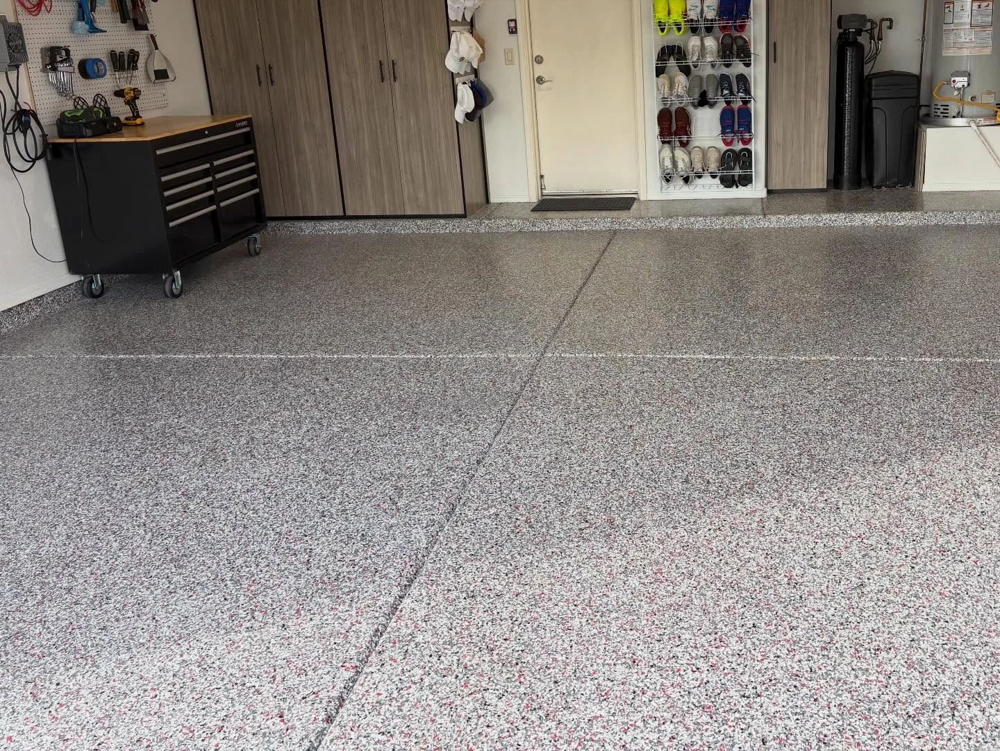 Clean, organized garage with polished epoxy floor and storage cabinets.