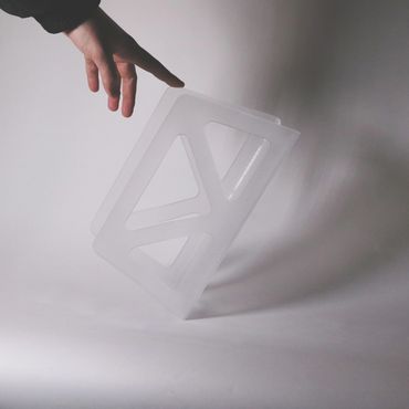 Bent acrylic paper holder, heat-shaped and laser cut with foggy sanded finish – 2025.