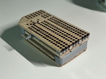 Portable Magnetic Cribbage Board, made from wood and plastic, with screws as pegs on the side. 2024