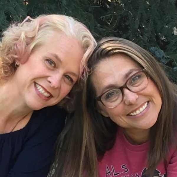 One woman with blond hair and one woman with brown hair, both smiling
