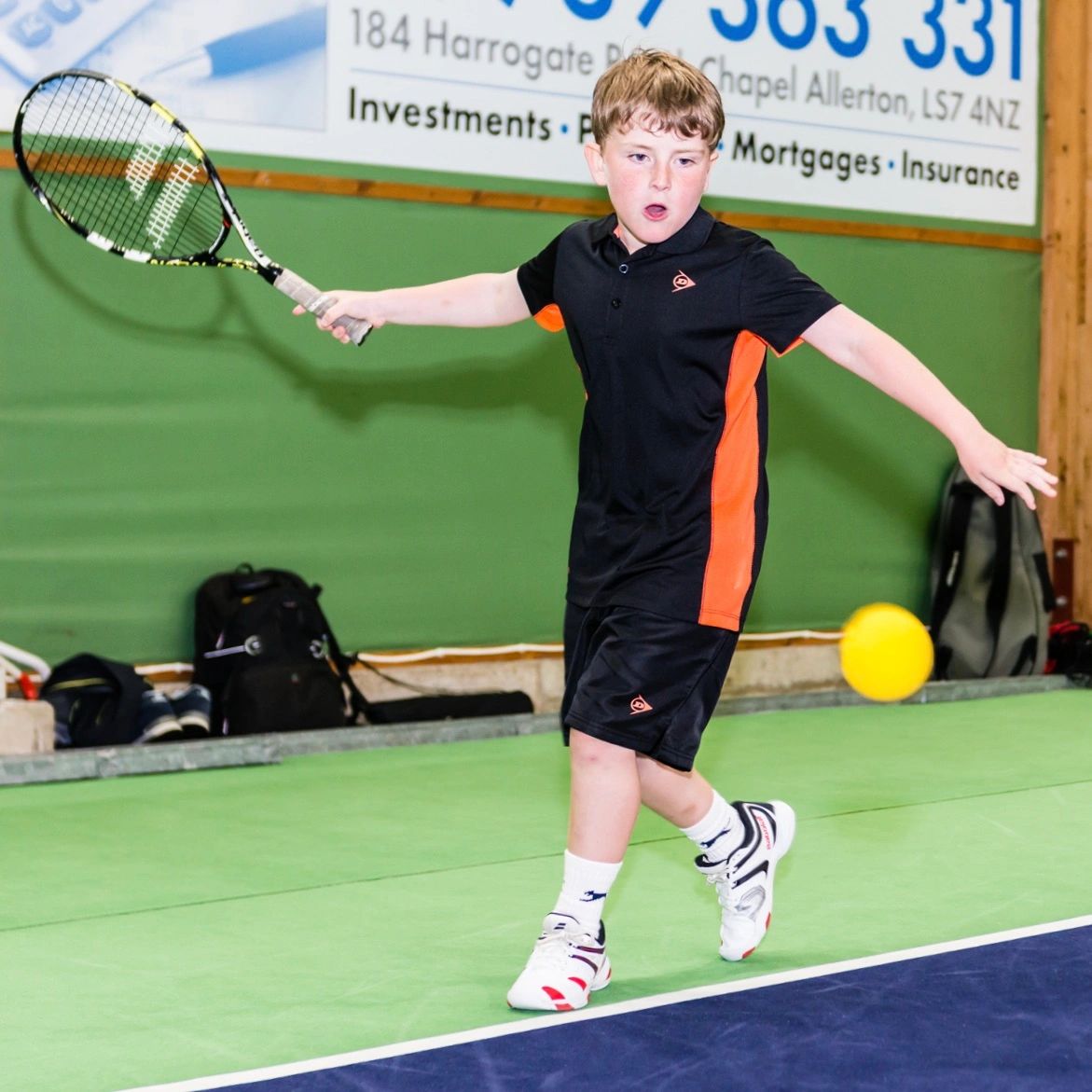 Junior Tennis hitting a tennis ball in Leeds.