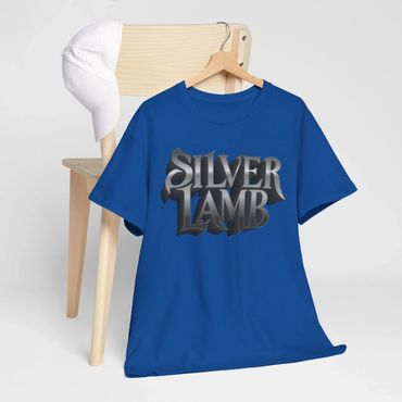 Blue T-shirt with bold 'Silver Lamb' text, hanging on a wooden chair with a white cap.