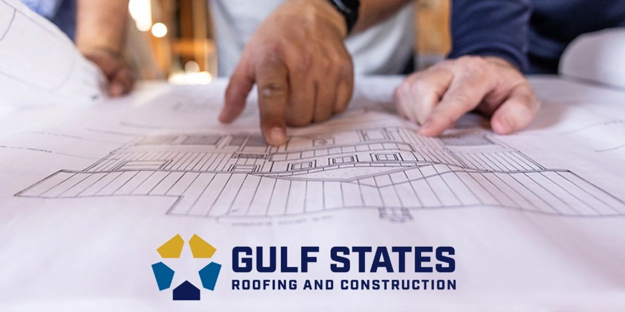 professional image of project managers looking at a blueprint