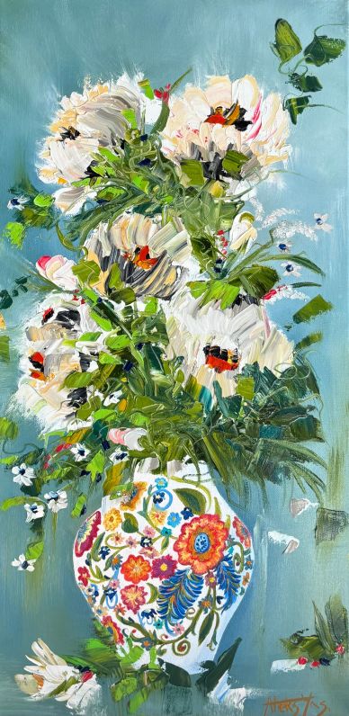 Colorful floral bouquet in a decorative vase against a soft blue background.