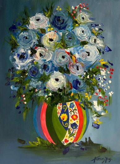 Colorful floral bouquet in a decorative vase against a blue background.