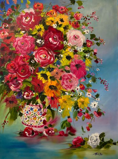 Vibrant bouquet of assorted flowers in a decorative vase.