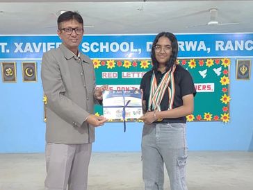 Student receiving an award at St. Xavier School.
