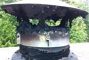 a chimney cap displaying a large amount of creosote build up