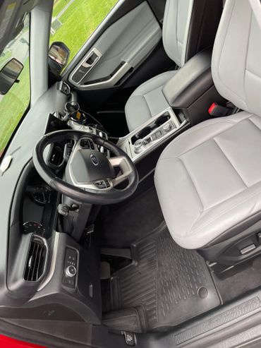 Modern Ford Explorer car interior with leather seats and advanced controls.
